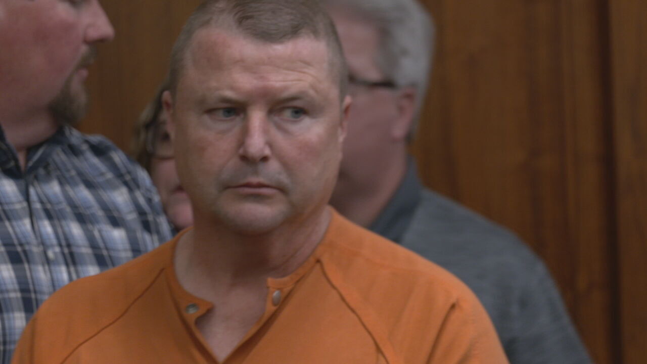 Jamey Noel in orange jumpsuit